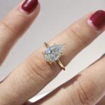 Hidden Halo Ring with pear-cut centre diamond, sleek cat claws, and delicate melee diamond halo set in luxurious recycled gold or platinum,