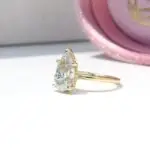 Hidden Halo Ring with pear-cut centre diamond, sleek cat claws, and delicate melee diamond halo set in luxurious recycled gold or platinum, handcrafted in Johannesburg.