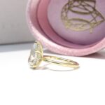 Hidden Halo Ring with pear-cut centre diamond, sleek cat claws, and delicate melee diamond halo set in luxurious recycled gold or platinum,