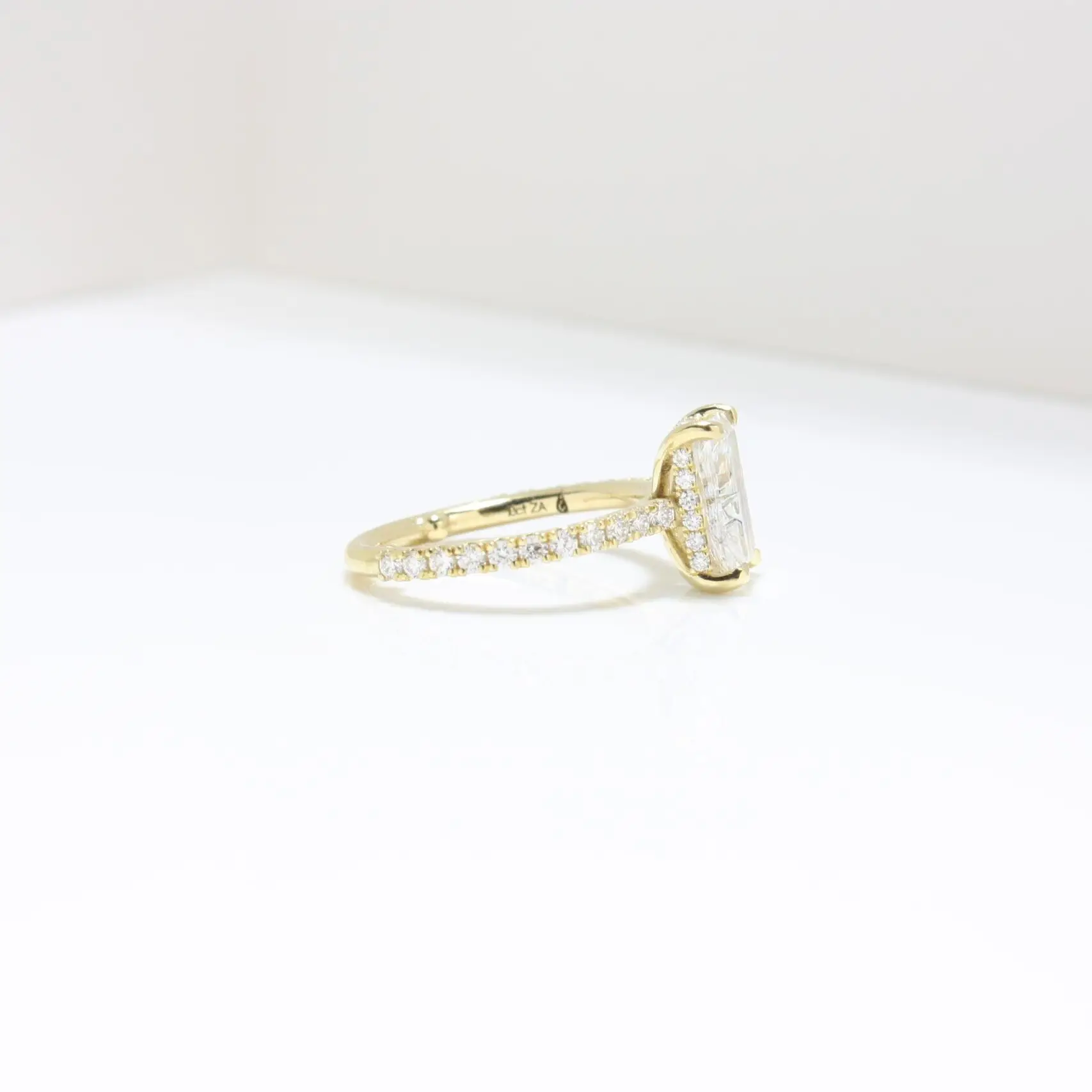 Pavé Hidden Halo Ring with radiant-cut centre stone, sleek cat claws, and delicate melee diamond halo set in luxurious recycled gold or platinum pavé band, handcrafted in Johannesburg.