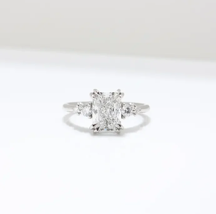 Duo Cluster Diamond Ring from Johannesburg, crafted in recycled gold or platinum. Radiant-cut centre stone with graduated round brilliant-cut diamonds in an open gallery setting, perfect for ethical and luxurious engagement rings.