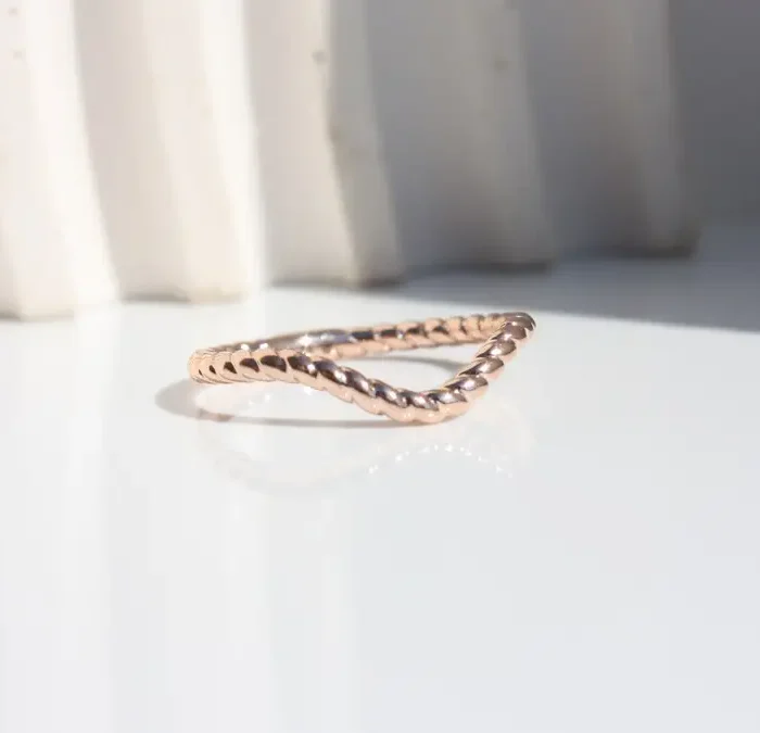 Contour Rope Ring handcrafted in Johannesburg from recycled rose gold featuring tightly interwoven twists and a gentle undulating curve. Designed to pair seamlessly with halo or trilogy engagement rings, creating an elegant, gap-free, luxury wedding ring.