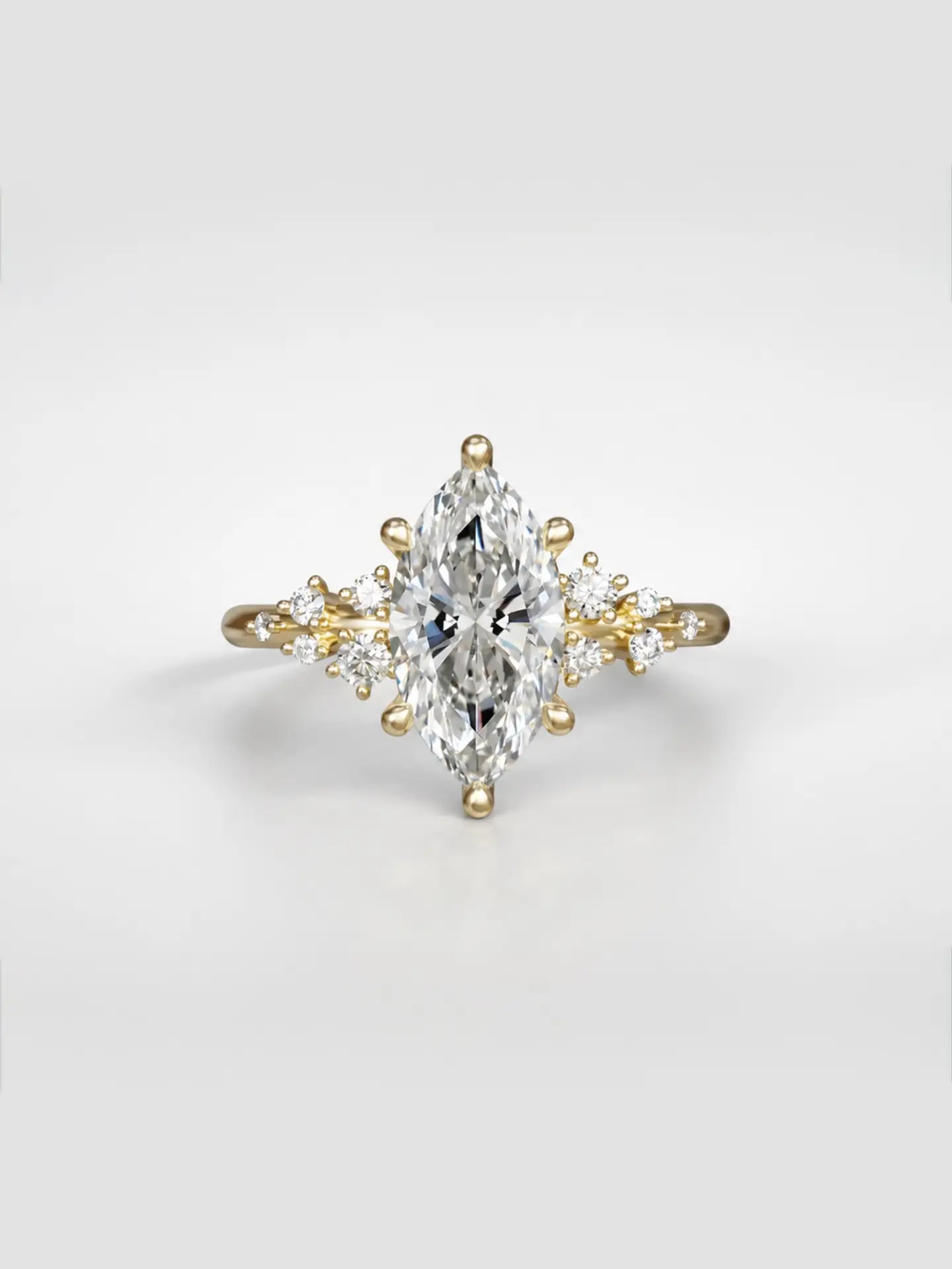 Gold cosmos cluster ring featuring a marquise cut diamond center stone and offset accent diamonds.