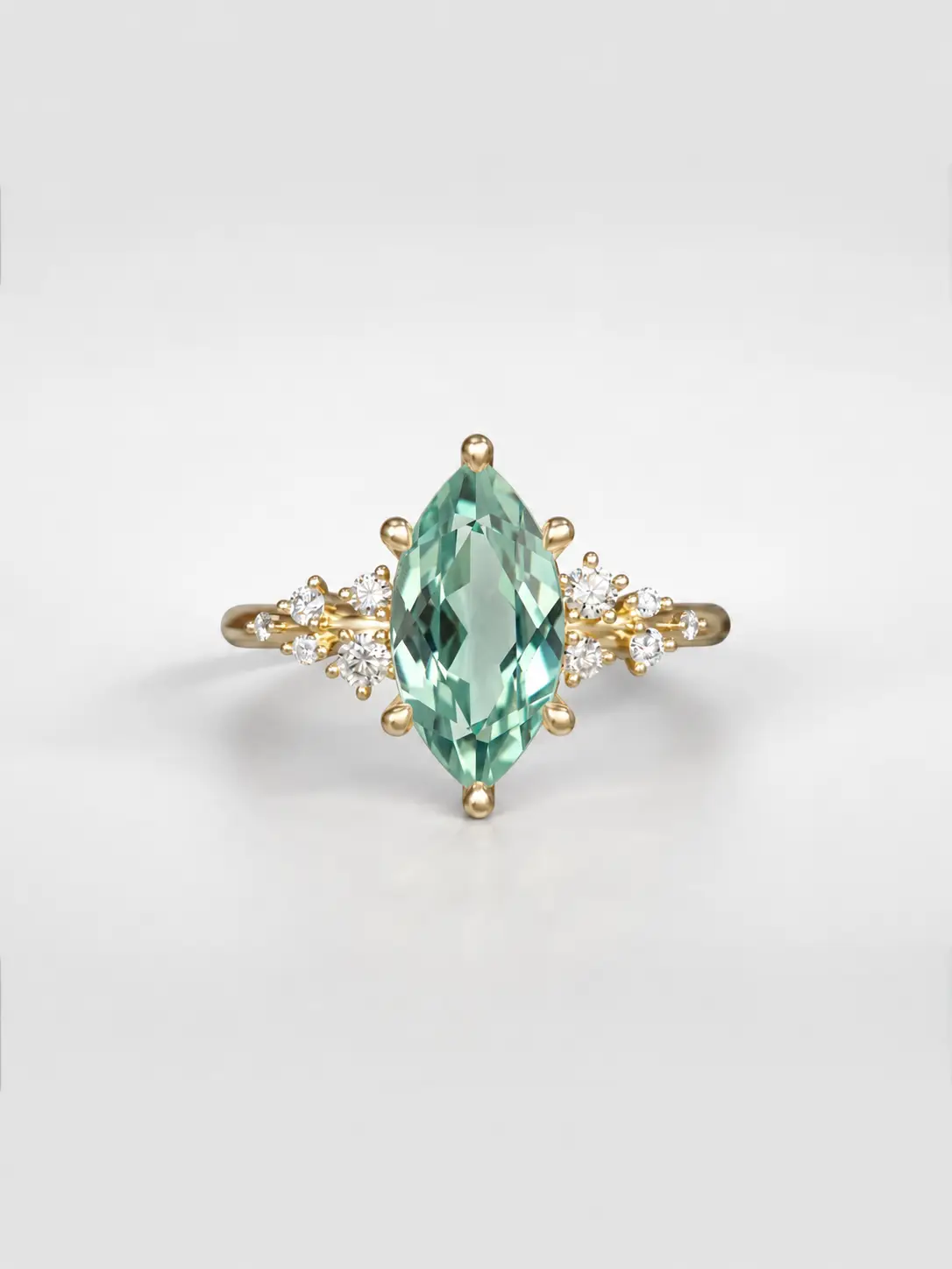 Gold cosmos cluster ring featuring a marquise Mint green tourmaline center stone and offset accent diamonds.