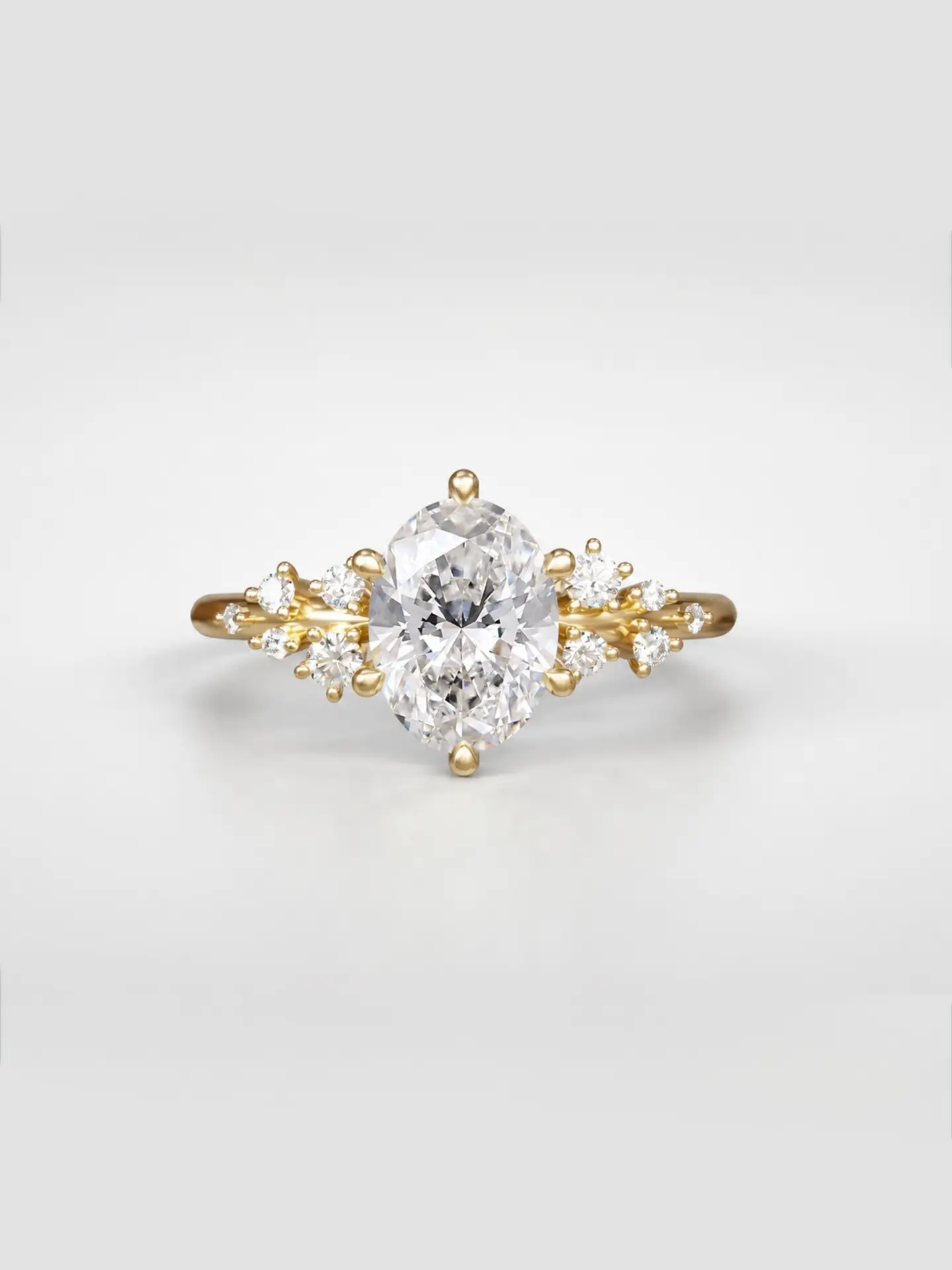 Gold cosmos cluster ring featuring a oval cut diamond center stone and offset accent diamonds.