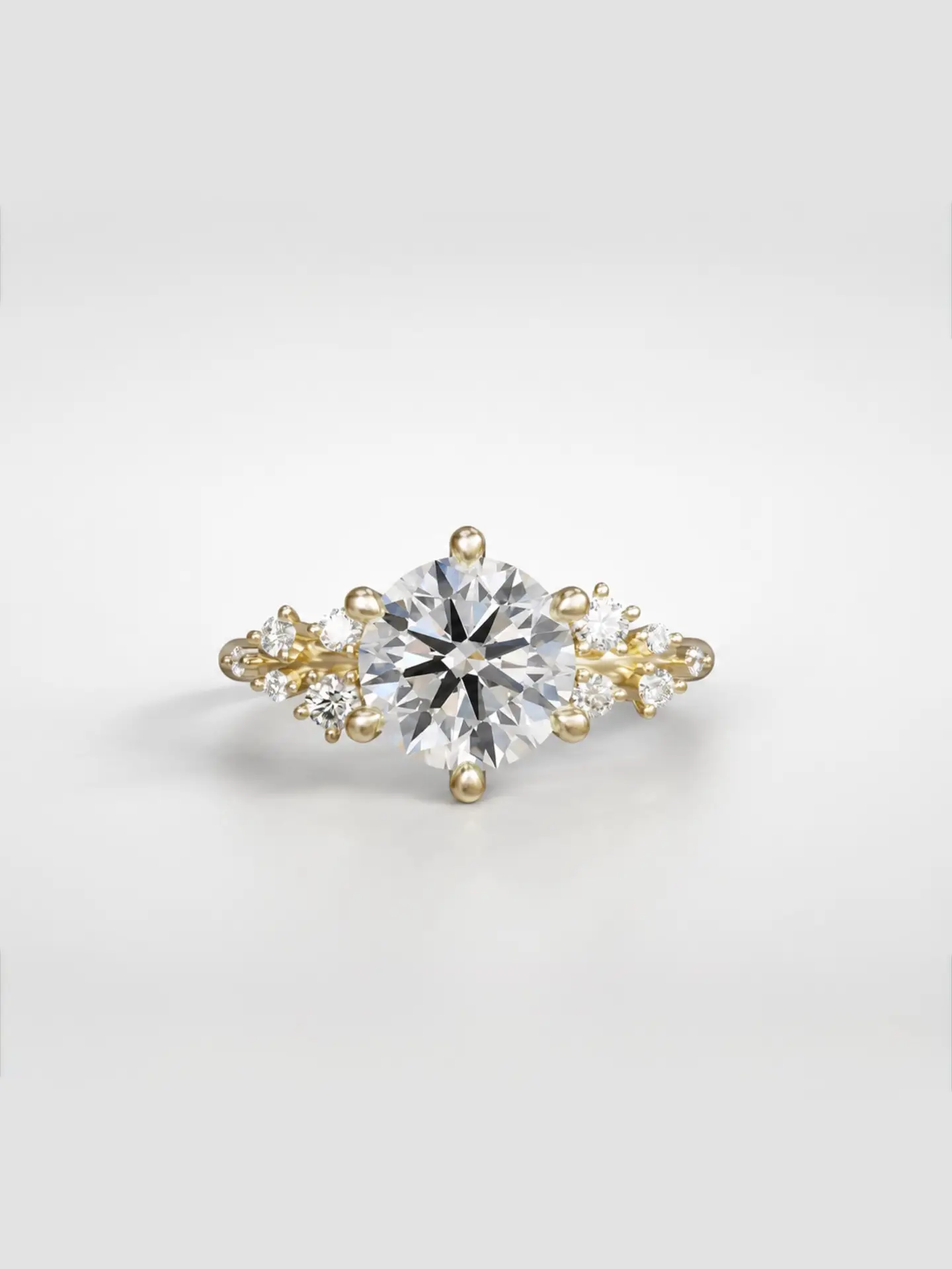 Gold cosmos cluster ring featuring a round cut diamond center stone and offset accent diamonds.