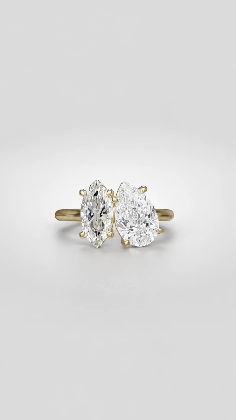 Toi et Moi diamond ring featuring a pear and marquise cut diamond pairing on a gold band.