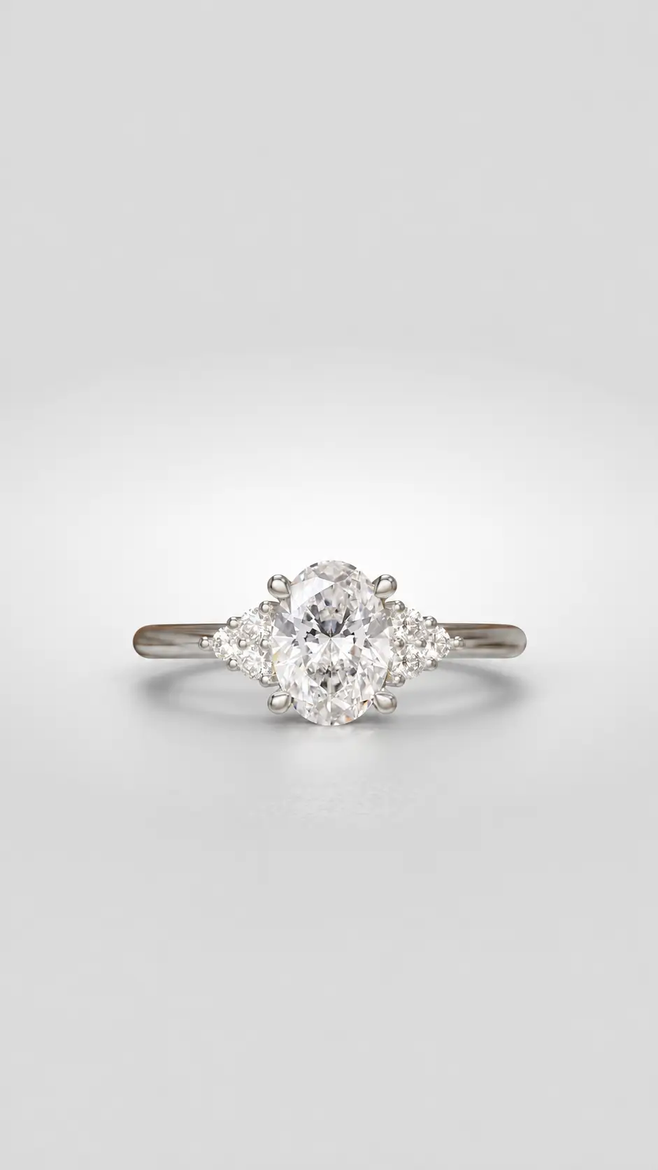Cluster diamond engagement ring with a oval center stone flanked by brilliant accent diamonds on a gold cathedral setting.