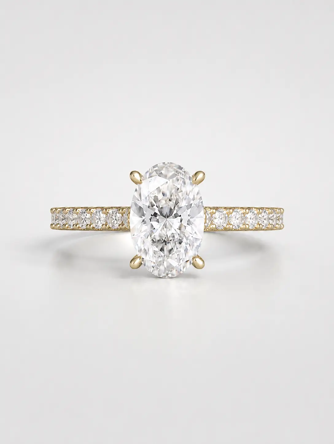 Oval diamond solitaire ring with a gold pavé band.