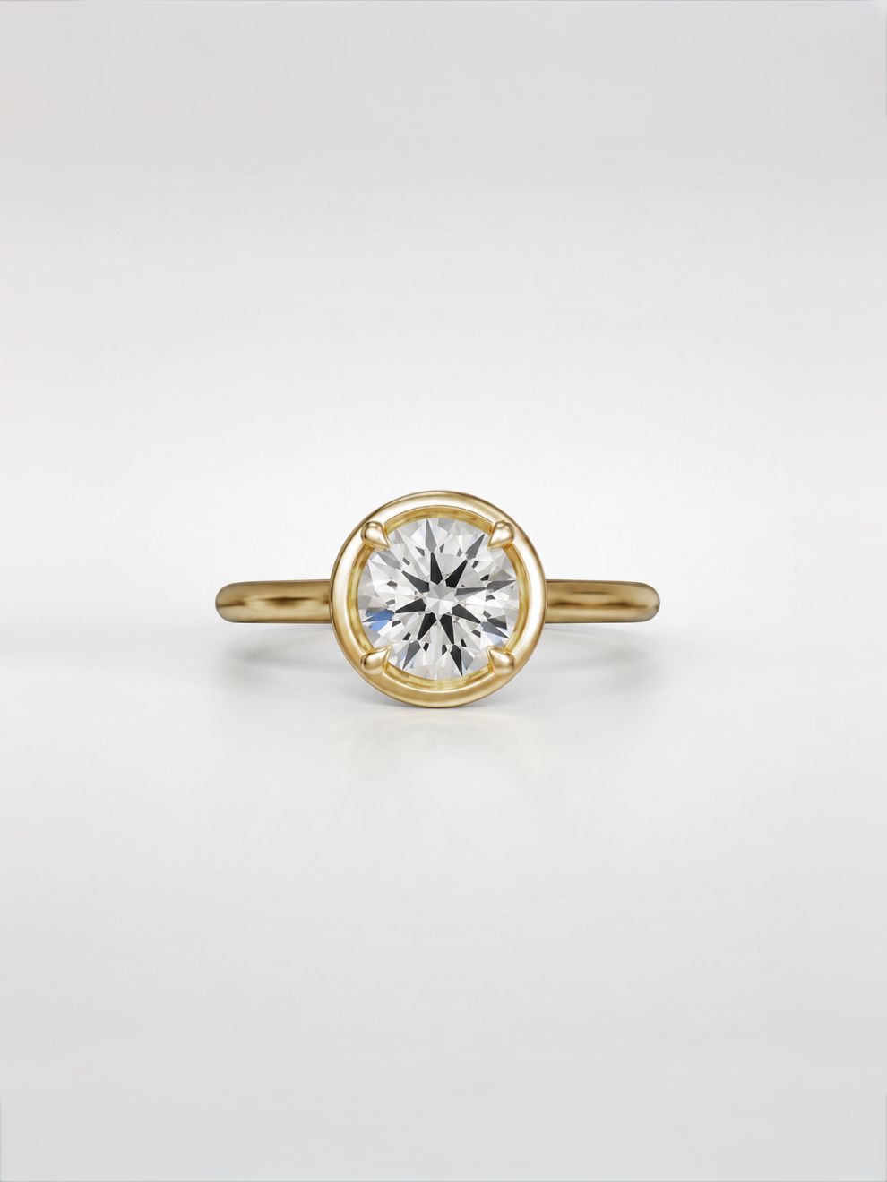 Round diamond solitaire ring with a tube accent and yellow gold cathedral setting.
