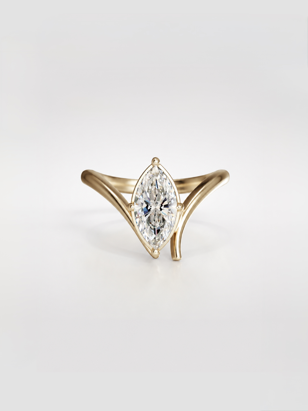 Marquise brilliant-cut diamond solitaire ring with cascading gold band.