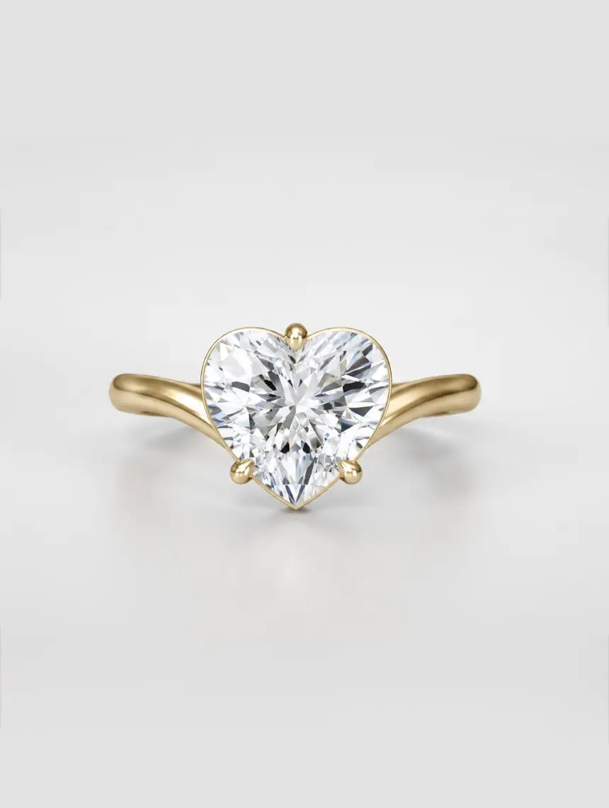 Heart brilliant-cut diamond solitaire ring with cascading gold band.